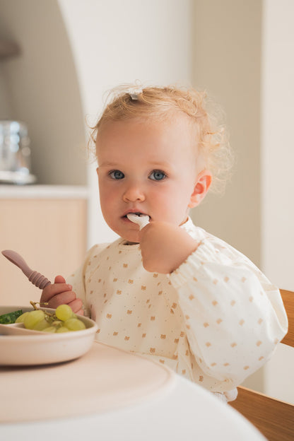 Bavette à manches longues avec pochette intégrée